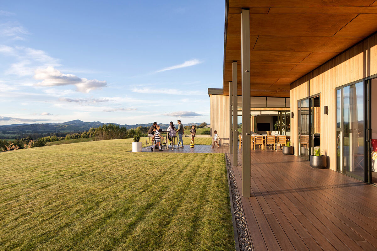 Luxury property at dusk with warm lighting and rural views